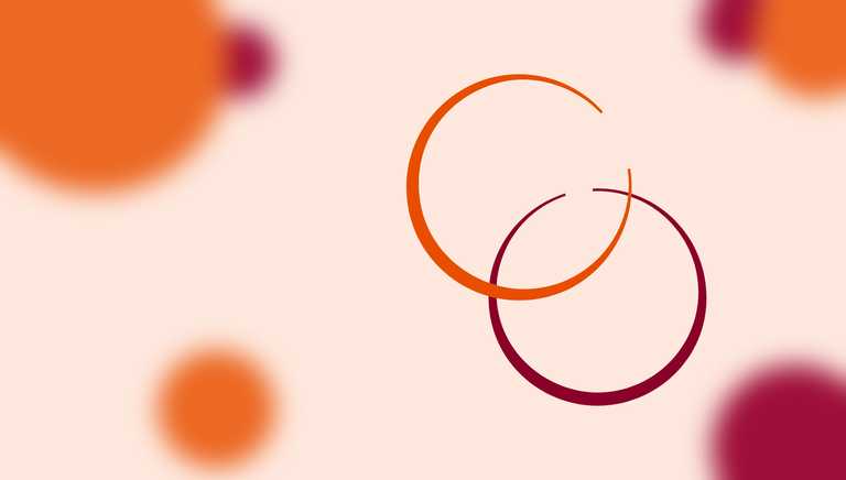 In the foreground, an orange circle overlaps a maroon circle - they resemble rings left behind by drinks. In the background, solid circles of colour are out of focus.