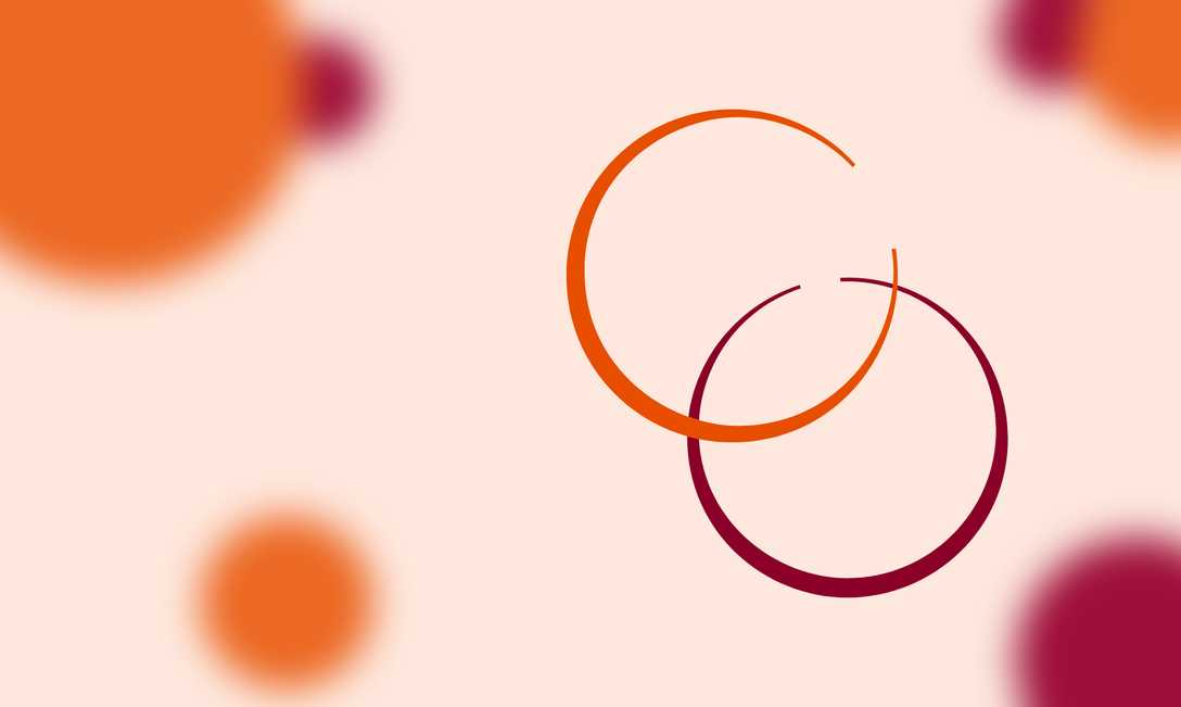 In the foreground, an orange circle overlaps a maroon circle - they resemble rings left behind by drinks. In the background, solid circles of colour are out of focus.