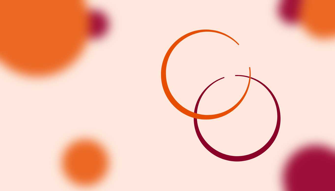 In the foreground, an orange circle overlaps a maroon circle - they resemble rings left behind by drinks. In the background, solid circles of colour are out of focus.