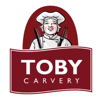 The Toby Carvery logo. Above 'Toby Carvery', written in a red banner, Toby the chef is smiling, wearing a chef's jacket and hat while holding carvery tools.